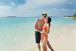 happy young couple have fun on beach photo