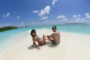 happy young couple have fun on beach photo