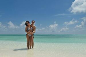 happy young couple have fun on beach photo