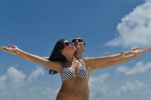 happy young couple have fun on beach photo