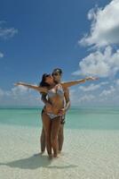 happy young couple have fun on beach photo