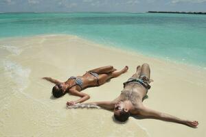 happy young couple have fun on beach photo