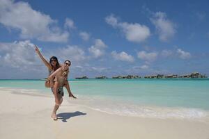 happy young couple have fun on beach photo