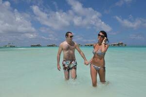 happy young couple have fun on beach photo