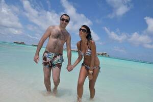 happy young couple have fun on beach photo