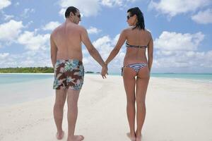 happy young couple have fun on beach photo