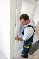 carpenters installing glass door with a wooden frame photo