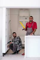 young workers installing a new kitchen photo