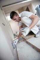 construction worker plastering on gypsum walls photo