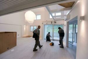 carpenters installing a balcony door photo