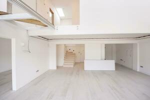 Interior of empty stylish modern open space two level apartment photo