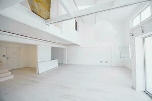 Interior of empty stylish modern open space two level apartment photo