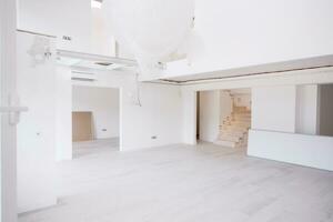 Interior of empty stylish modern open space two level apartment photo