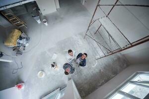 top view of Workers and builders with dirty uniform in apartment photo