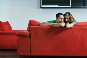 happy couple relax on red sofa photo