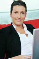 oung business woman working on laptop at home photo