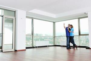 happy couple in empty apartment photo