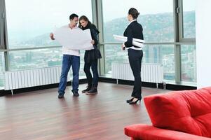 happy young couple buying new home with real estate agent photo