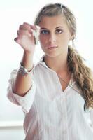 young woman throwing home keys in air photo