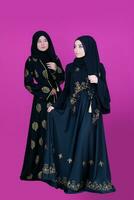 two hijab muslim woman on pink background photo