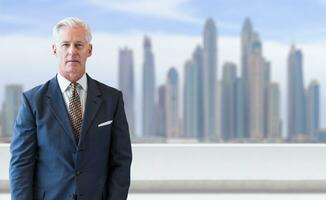 Senior businessman in front of the big city photo