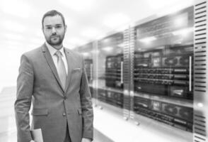 Young businessman in server room photo