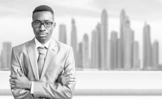 Young black businessman in front of the big city photo