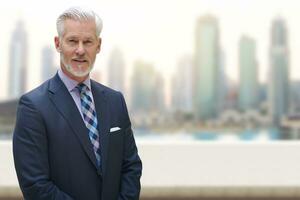 Senior businessman in front of the big city photo