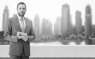 Young businessman in front of the big city photo