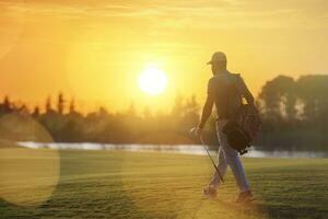 handsome middle eastern golfer carrying bag and walking to next hole photo