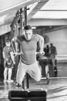 man doing exercises parallel bars photo