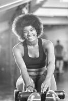 black woman doing sit ups at the gym photo