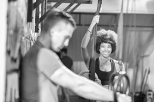 Portrait of multiethnic couple  after workout at gym photo