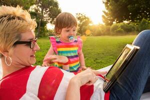 mom and a little daughter relaxing in a hammock photo