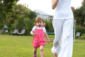 mother and little daughter playing at backyard photo