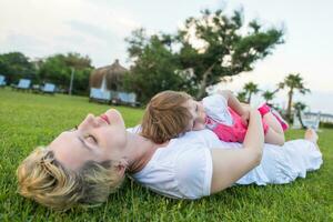 mother and little daughter playing at backyard photo