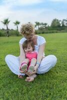 mother and little daughter playing at backyard photo