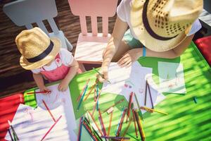 mom and little daughter drawing a colorful pictures photo