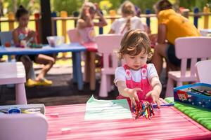 little girl drawing a colorful pictures photo