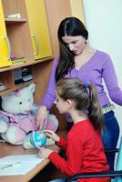 mom and girl doing homework at home photo