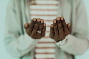 Young African Muslim Man Making Traditional Fatiha Prayer To Allah photo