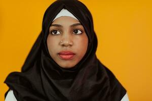 Muslim woman with a beautiful smile wearing a hijab poses in the studio photo