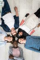 Top view of a diverse group of people lying on the floor and symbolizing togetherness photo