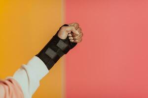 isolated hurt hand of African American girl on yellow background photo