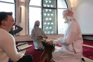 muslim people in mosque reading quran together photo