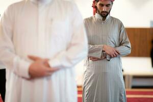 group of muslim people praying namaz in mosque. photo