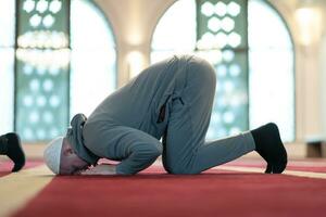 man performing sajdah in namaz photo