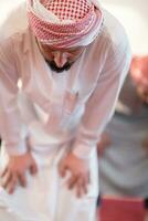 group of muslim people praying namaz in mosque. photo