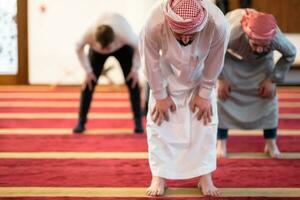 group of muslim people praying namaz in mosque. photo