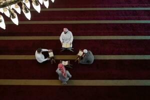 muslim people in mosque reading quran together photo